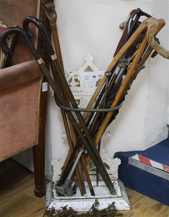 A Victorian cast iron stick stand and sticks